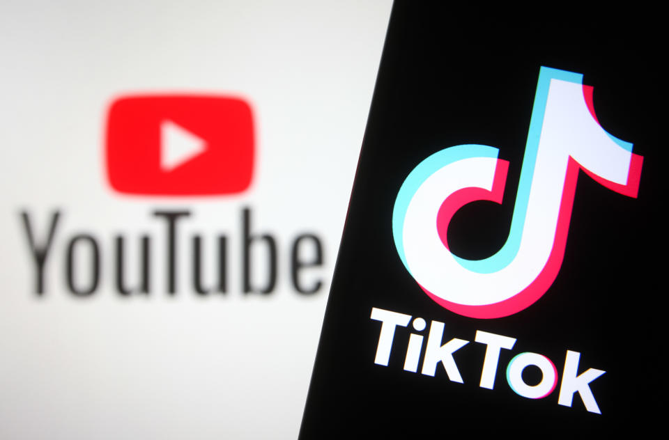 UKRAINE - 2021/10/23: In this photo illustration a TikTok logo is seen on a smartphone screen with a YouTube logo of an online video sharing and social media platform in the background. (Photo Illustration by Pavlo Gonchar/SOPA Images/LightRocket via Getty Images)