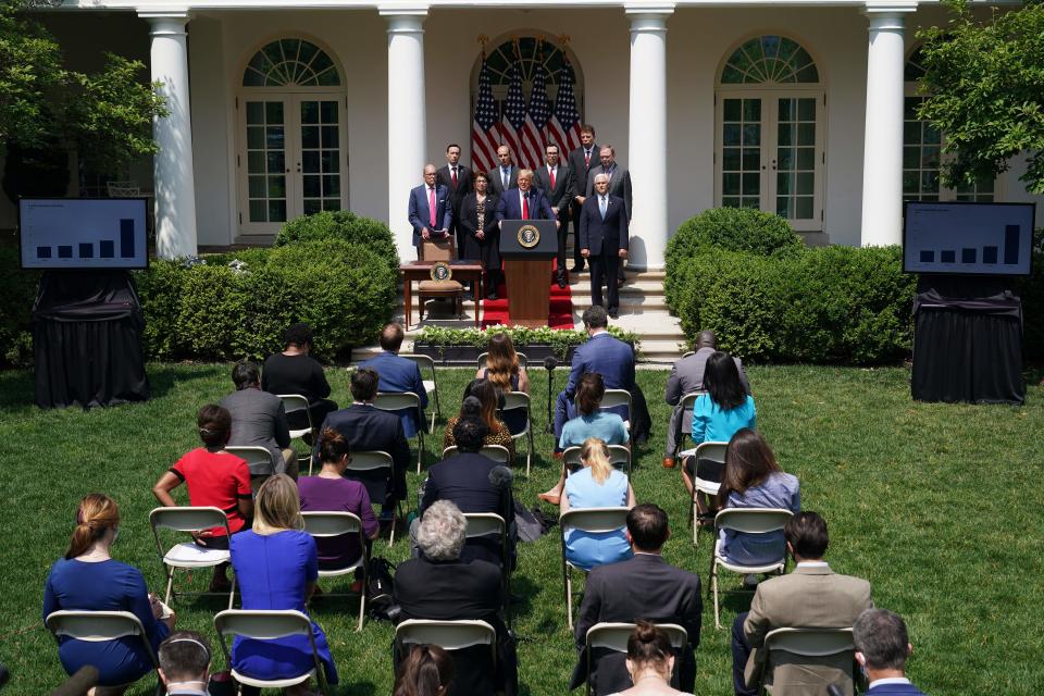 President Donald Trump, with Director of the National Economic Council Larry Kudlow (L), holds a press conference on the economy, in the Rose Garden of the White House in Washington, DC, on June 5, 2020. (Mandel Ngan/AFP via Getty Images)