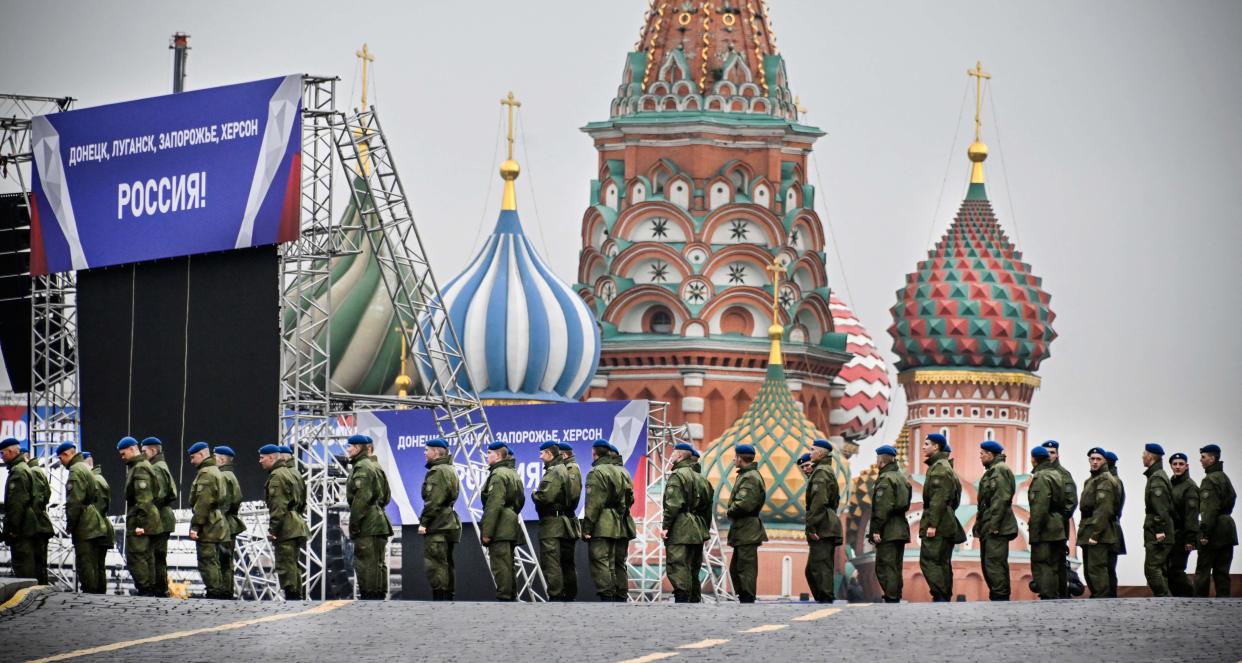 Russian soldiers stand on Red Square in central Moscow on Sept. 29, 2022, as the square is sealed prior to a ceremony of the incorporation of the new territories into Russia. Banners on the stage read: "Donetsk, Lugansk, Zaporizhzhia, Kherson - Russia!"