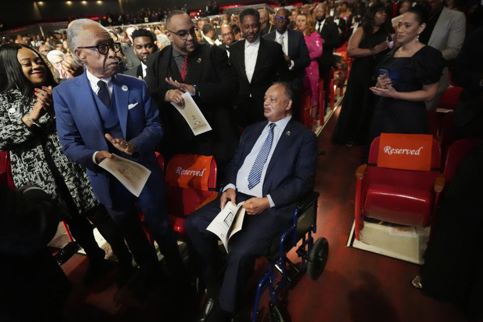 The Rev. Jesse Jackson, seated, is applauded by the Rev. Al Sharpton, front left, and others in Dallas, Thursday, Feb. 1, 2024. The civil rights group founded by the Rev. Jackson in the 1970s is elevating a new leader for the first time in more than 50 years, choosing the Rev. Frederick D. Haynes III as his successor to take over the Rainbow PUSH Coalition. (AP Photo/LM Otero)