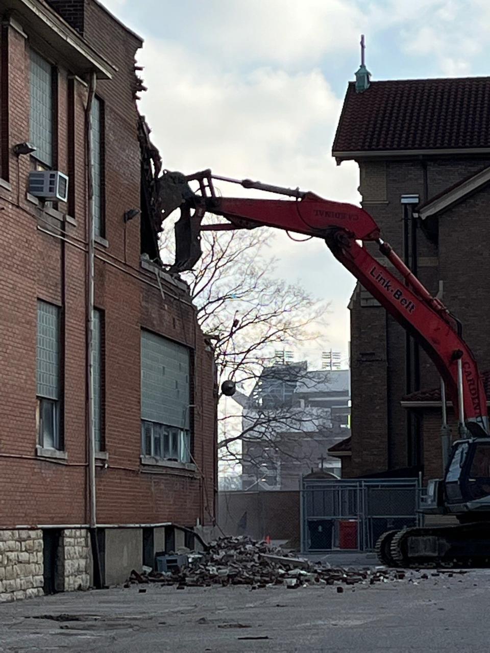 Crews work Monday morning to tear down aging buildings on the Catholic Charities of Louisville campus at 2911 S. Fourth Street. Feb. 14, 2022