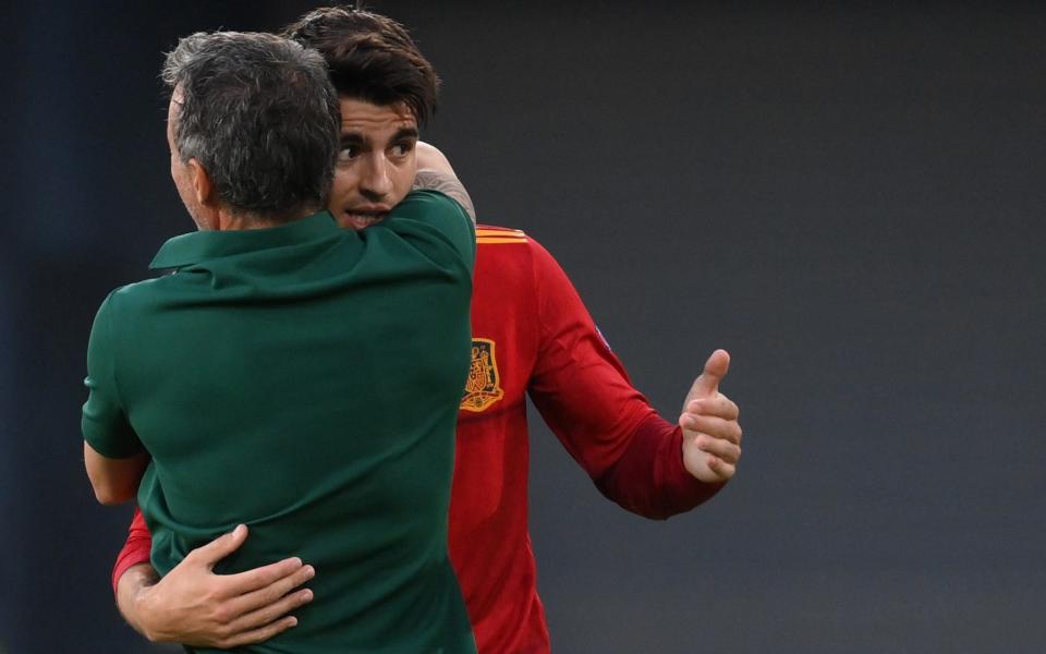 Morata embraces Spain manager Luis Enrique in the aftermath of the goal - AFP