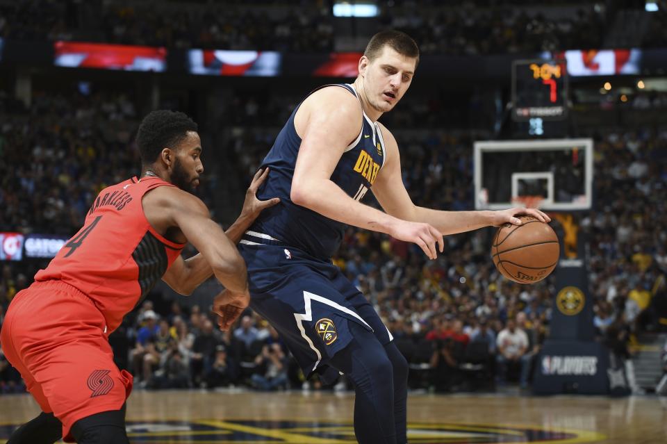 Denver Nuggets center Nikola Jokic, right, works the ball inside to the rim as Portland Trail Blazers forward Maurice Harkless defends in the first half of Game 7 of an NBA basketball second-round playoff series Sunday, May 12, 2019, in Denver. (AP Photo/John Leyba)