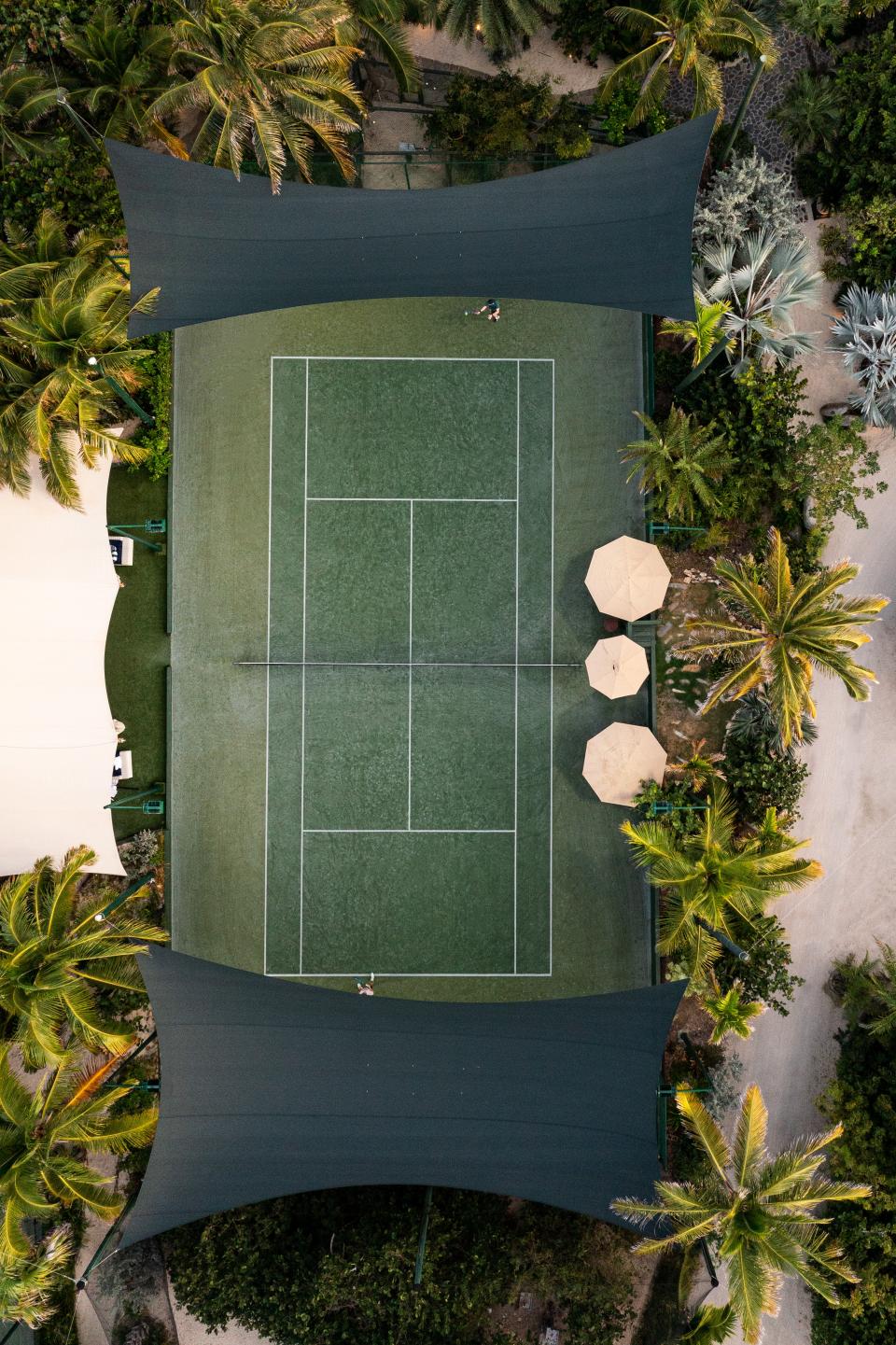 Tennis courts abut the island's beachfront as well as the lemur and parrot enclosures