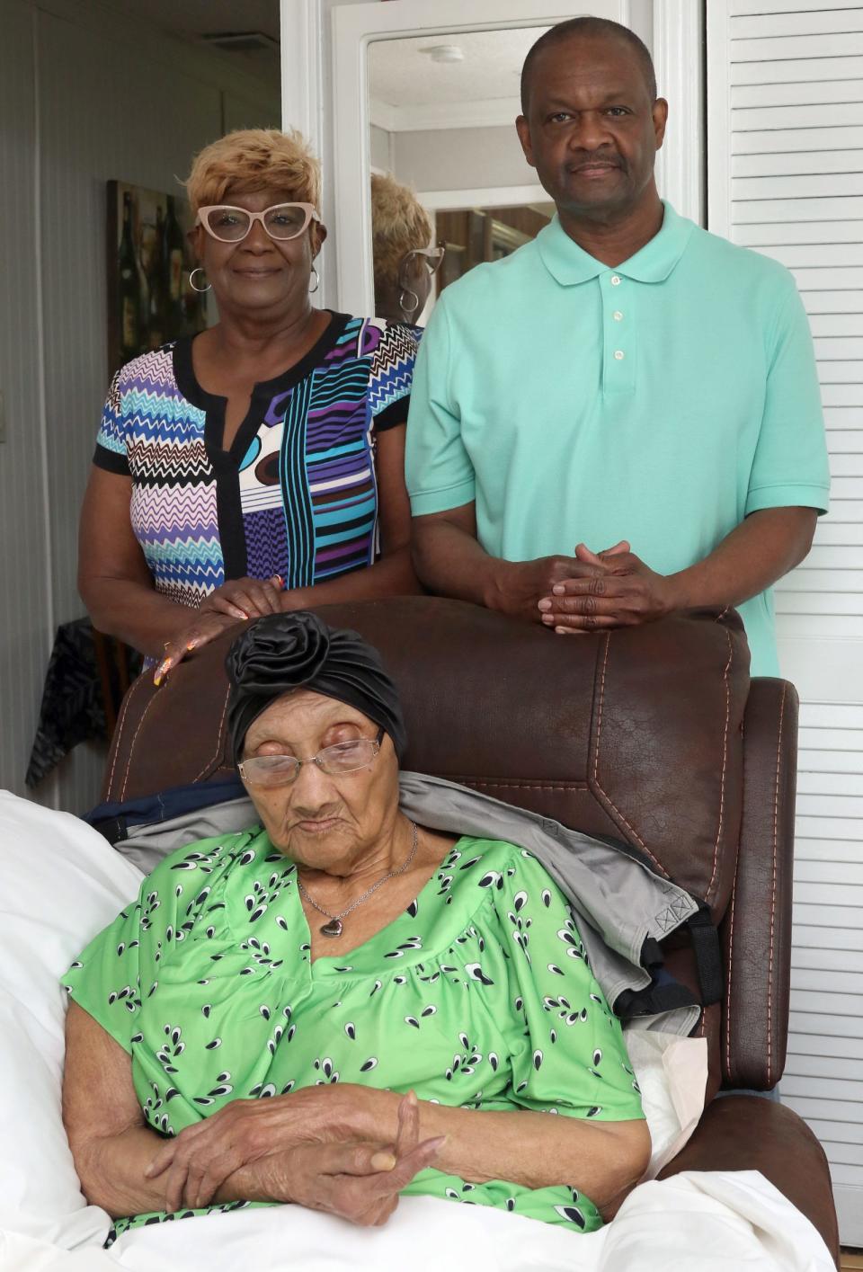 Myrtice Barnwell and Anthony Cook pose with their 106-year-old mother, Blanche Cook, Monday afternoon, May 6, 2024.