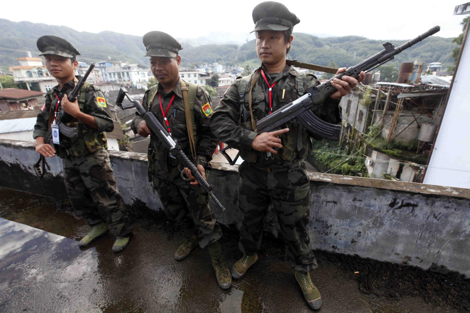 FILE - In this Oct. 29, 2013, file photo, soldiers of the Kachin Independence Army (KIA) stand on guard in Laiza, a border town of China and Myanmar, Kachin State, Myanmar. The Kachin Independence Army claims to have shot down a helicopter belonging to the government’s military Monday, May 3, 2021, in the course of heavy fighting over a strategic position. (AP Photo/Khin Maung Win, File)