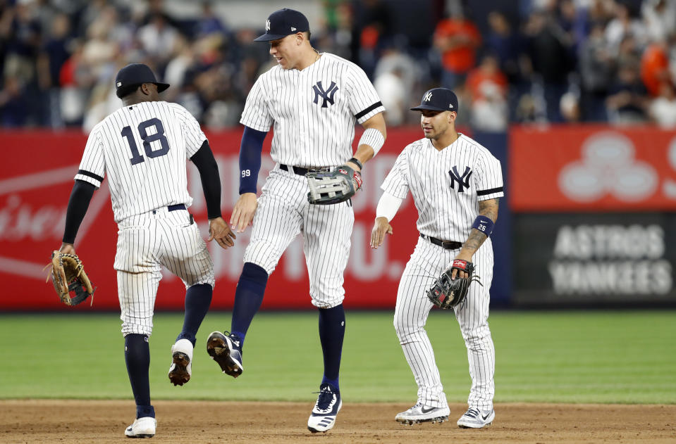 New York Yankees shortstop Didi Gregorius (18) celebrates with right fielder Aaron Judge, center, and second baseman Gleyber Torres after the Yankees defeated the Houston Astros 4-1 in a baseball game Friday, June 21, 2019, in New York. (AP Photo/Kathy Willens)