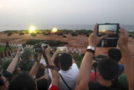 Local residents take pictures during the annual Han Kuang military exercise in Kinmen, Taiwan, September 8, 2015. REUTERS/Pichi Chuang