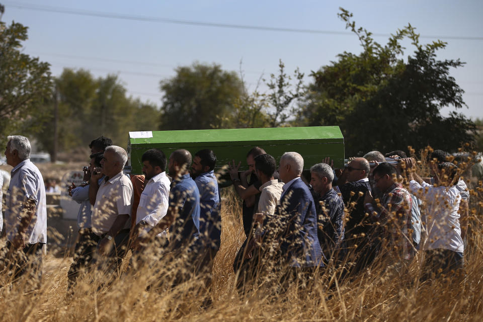 Mourners carry the coffin of Halil Yagmur, 64 killed Friday during mortar shelling from Syria, during a funeral procession in the town of Suruc, southeastern Turkey, at the border with Syria, Saturday, Oct. 12, 2019. Turkey says its military offensive has taken central Ras al-Ayn, a key border town in northeastern Syria, and its most significant gain since its cross-border operation began against Syrian Kurdish fighters began. (AP Photo/Emrah Gurel)