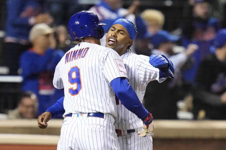 New York Mets' Francisco Lindor, right, celebrates with Brandon Nimmo (9) after they scored on a double by Jeff McNeil during the third inning of a baseball game against the San Diego Padres, Monday, April 10, 2023, in New York. (AP Photo/Frank Franklin II)