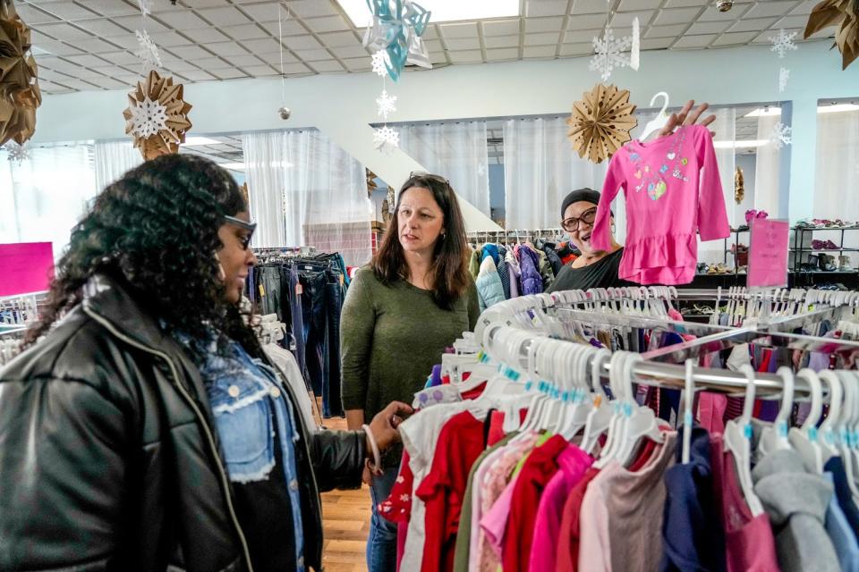 Helping Sonya Morris, left, with some shopping at Foster Forward's Community Storefront in Pawtucket are Melanie Borges, center, and Grace DaVila. Borges volunteers at the store that was a crucial resource for her when she took in a foster child in 2018 with only a few hours' notice.