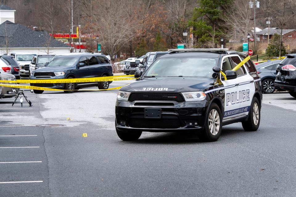 A Hendersonville Police Department car sits within a crime scene at Brittany Estates Circle in Hendersonville Feb. 23, 2024. Police responded the morning of Feb. 23 to a shooting by an off-duty Henderson County Sheriff's deputy, who injured a person.