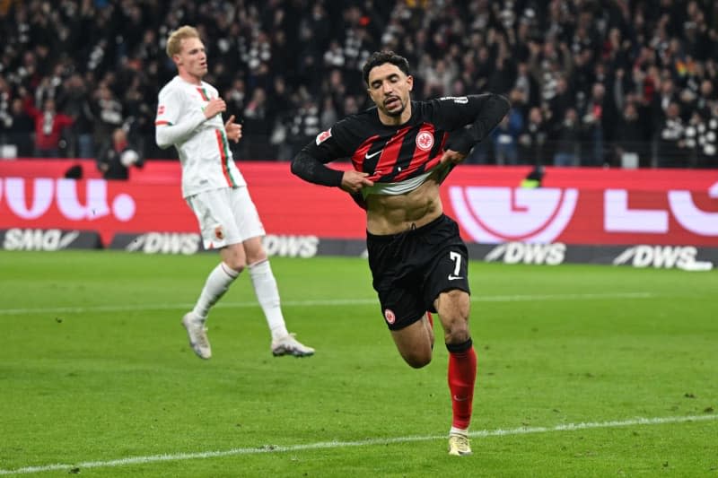 Frankfurt's Omar Marmoush celebrates scoring his side's third goal during the German Bundesliga soccer match between Eintracht Frankfurt and FC Augsburg at Deutsche Bank Park. Arne Dedert/dpa