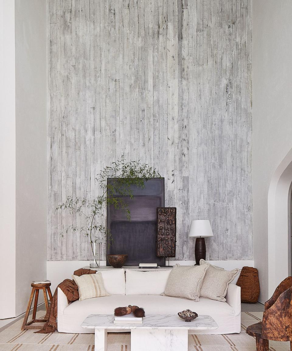 living room with white textured walls and white sofa