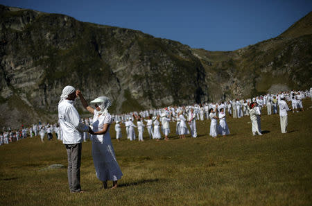 Followers of the Universal White Brotherhood, an esoteric society that combines Christianity and Indian mysticism set up by Bulgarian Peter Deunov in the 1920s, perform a dance-like ritual called "paneurhythmy" in Rila Mountain, Bulgaria, August 19, 2017. REUTERS/Stoyan Nenov