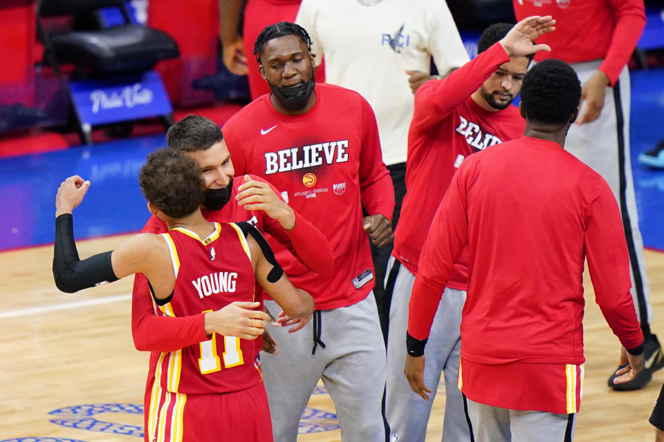 Atlanta Hawks' Trae Young, left, and Bogdan Bogdanovic embrace after the Hawks won Game 5 in a second-round NBA basketball playoff series against the Philadelphia 76ers, Wednesday, June 16, 2021, in Philadelphia. (AP Photo/Matt Slocum)