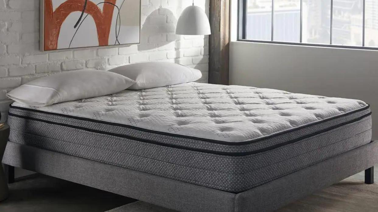  Are firm mattresses better for your back? Best firm mattress on bedframe with abstract art  