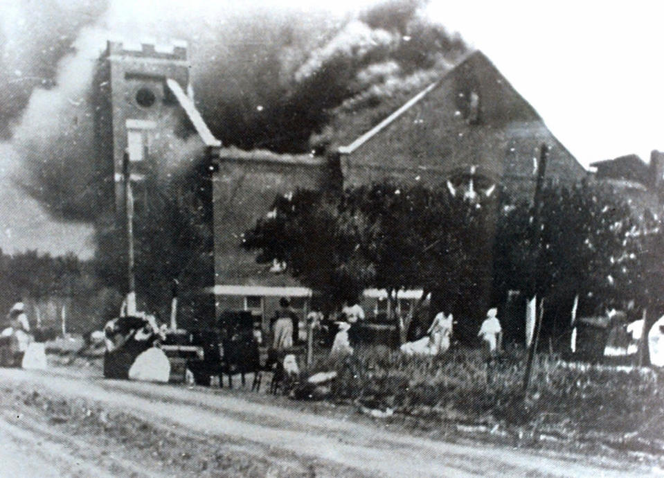 FILE - In this 1921 file image provided by the Greenwood Cultural Center via Tulsa World, Mt. Zion Baptist Church burns after being torched by white mobs during the 1921 Tulsa massacre. Black community and political leaders called on President Donald Trump to at least change the Juneteenth date for a rally kicking off his return to public campaigning, saying Thursday, June 11, 2020. From Sen. Kamala Harris of California to Tulsa civic officials, black leaders said it was offensive for Trump to pick that date — June 19 — and that place — Tulsa, an Oklahoma city that in 1921 was the site of a fiery and orchestrated white-on-black killing spree. (Greenwood Cultural Center via Tulsa World via AP)