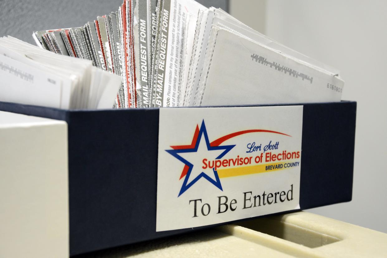 Absentee ballot requests fill a box at the Supervisor of Elections office in Viera.