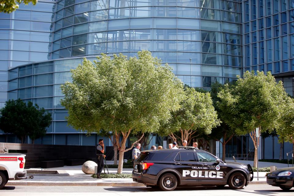 Oklahoma City police stand outside the Devon Tower after a person climbed the building in Oklahoma City, Tuesday, June 14, 2022. 