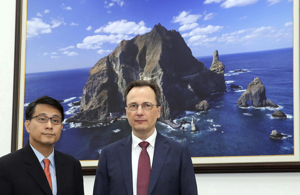 Yoon Sang-hyun, chairman of the South Korean parliament's foreign affairs committee, left, stands with acting Russian Ambassador to South Korea Maxim Volkov before their meeting at the National Assembly in Seoul, South Korea, Wednesday, July 24, 2019. Yoon cites Volkov as saying Russia wants an investigation into a South Korean announcement that a Russia military plane has violated its airspace. (Lee Jong-chul/Newsis via AP)