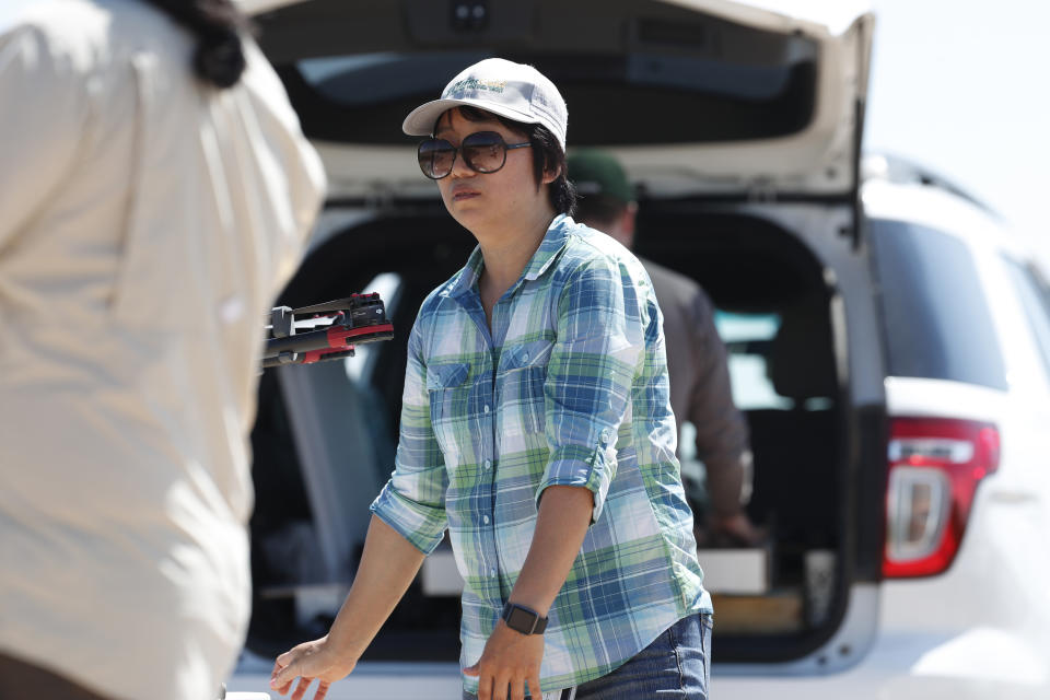 In this Thursday, July 11, 2019, photograph, Huihui Zhang at a research farm northeast of Greeley, Colo. Researchers are using drones carrying imaging cameras over the fields in conjunction with stationary sensors connected to the internet to chart the growth of crops in an effort to integrate new technology into the age-old skill of farming. (AP Photo/David Zalubowski)