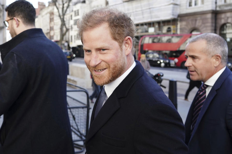 Britain's Prince Harry, center, arrives at the Royal Courts Of Justice, in London, Monday, March 27, 2023. Prince Harry was in a London court on Monday as the lawyer for a group of British tabloids prepared to ask a judge to toss out lawsuits by the prince, Elton John and several other celebrities who allege phone tapping and other invasions of privacy. (Jordan Pettitt/PA Wire/PA via AP)