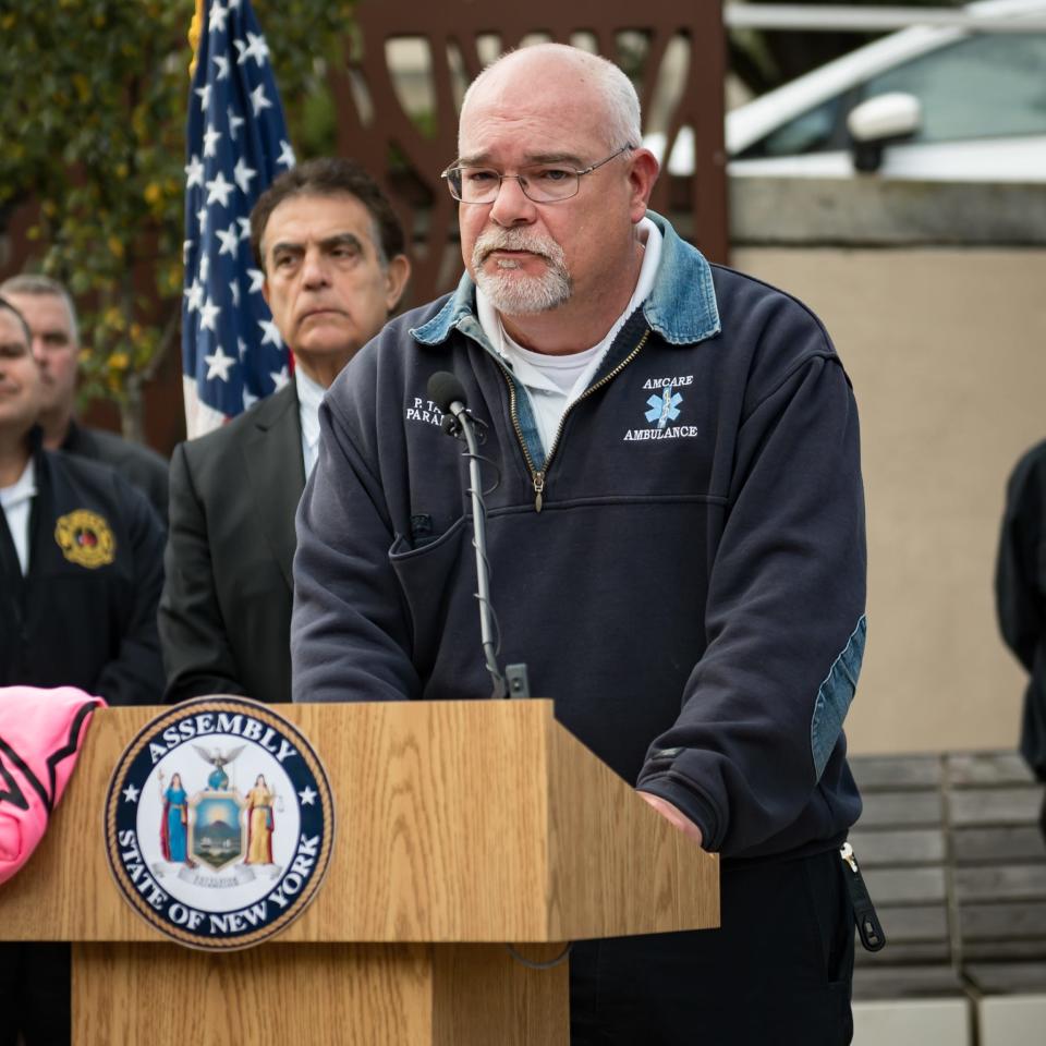 Paul Taylor of AmCare Ambulance Service, alongside lawmakers and other ambulance service providers, speaks during a unified call to action urging Governor Kathy Hochul to sign the "direct pay" legislation into law at the Utica State Office Building in Utica, NY on Thursday, October 12, 2023.