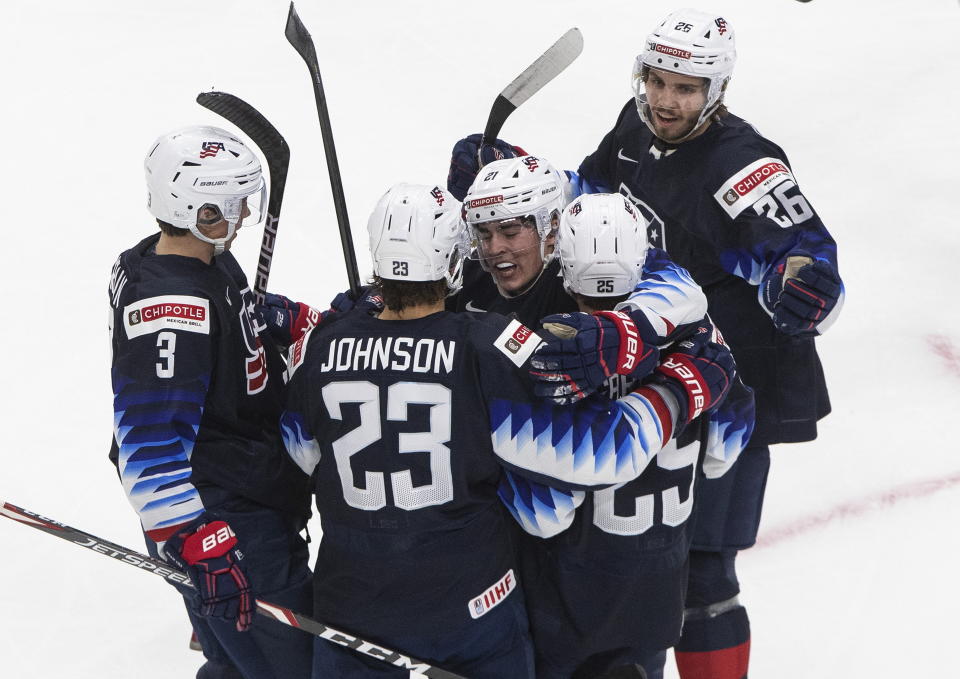 United States' Henry Thrun (3), Ryan Johnson (23), Brett Berard (21), John Farinacci (25) and Landon Slaggert (26) celebrate a goal against Slovakia during the second period of an IIHL World Junior Hockey Championship game, Saturday, Jan. 2, 2021 in Edmonton, Alberta. (Jason Franson/The Canadian Press via AP)