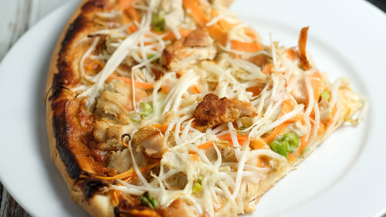 Slice of Thai chicken pizza