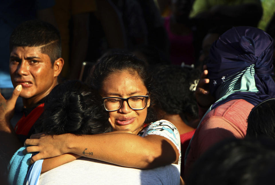 Women embrace outside Anisio Jobim Prison Complex after a deadly riot erupted among inmates in Manaus in the northern state of Amazonas, Brazil, Sunday, May 26, 2019. A statement from the state prison secretary says prisoners began fighting among themselves around noon Sunday, and security reinforcements were rushed to complex. (AP Photo/Edmar Barros)