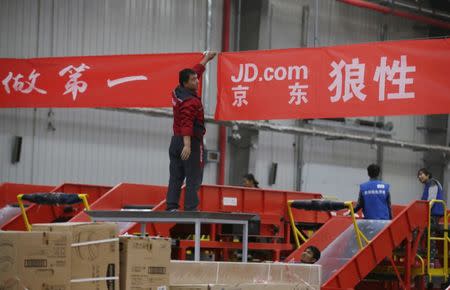 FILE PHOTO - An employee works at a JD.com logistics centre in Langfang, Hebei province, November 10, 2015. REUTERS/Jason Lee/File Photo