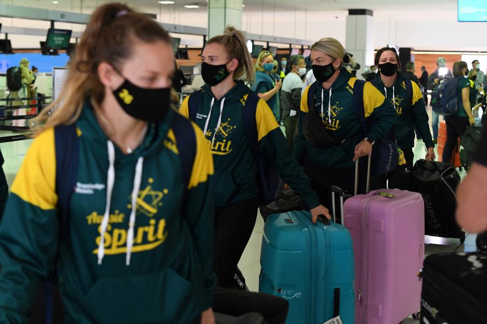 Australian softball players queue at the check-in counter prior to their departure for the Tokyo Olympics, at Sydney International Airport on May 31, 2021. (Photo by SAEED KHAN / AFP) (Photo by SAEED KHAN/AFP via Getty Images)