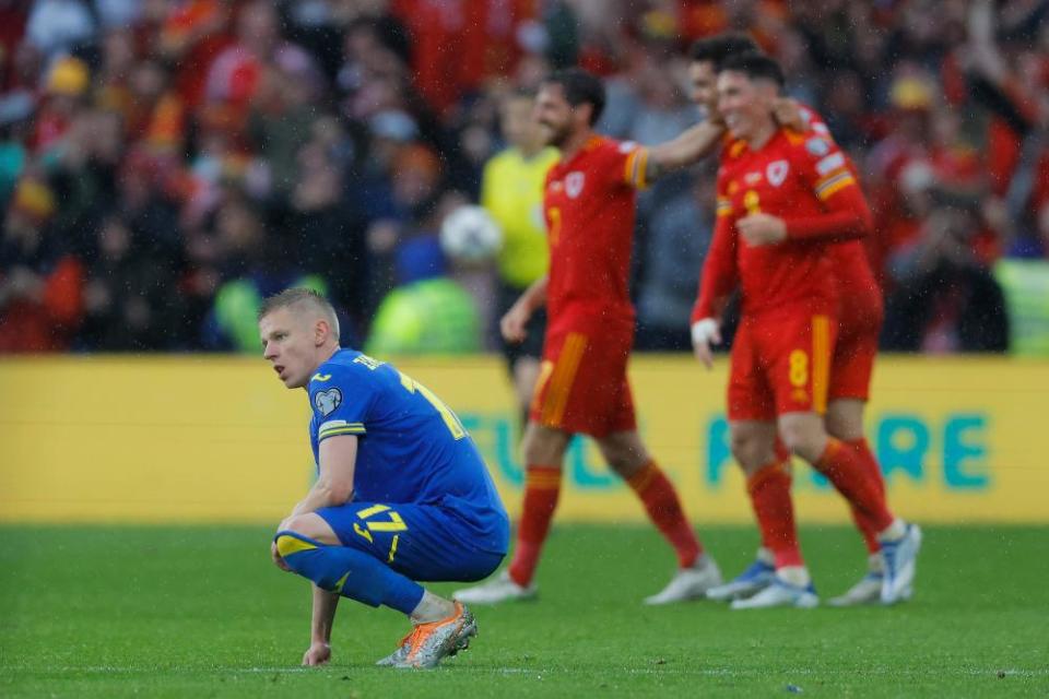 Ukraine’s Oleksandr Zinchenko sinks to the turf.