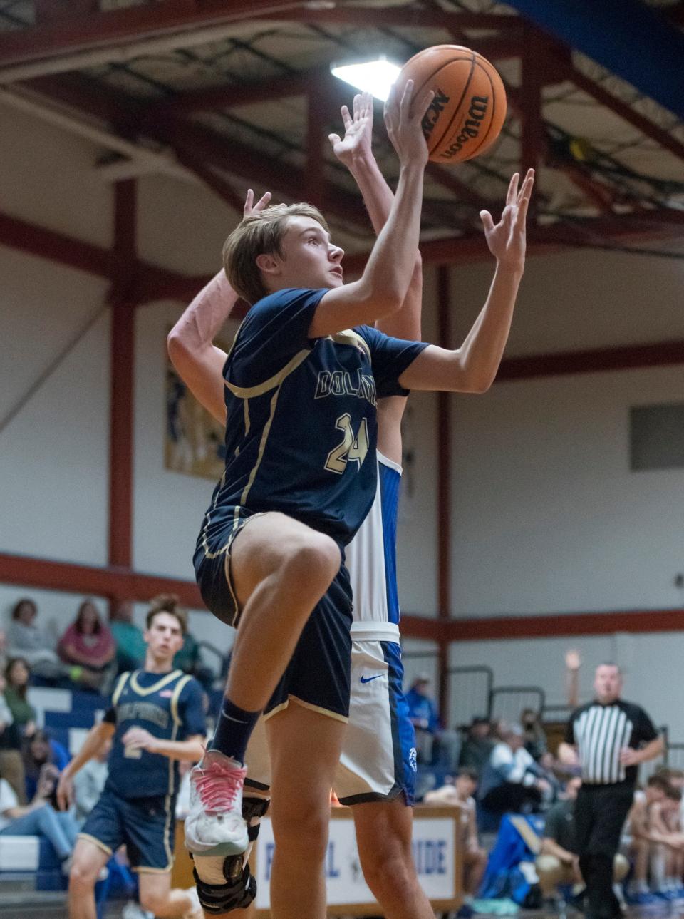 Jack Banks (24) shoots during the Gulf Breeze vs Jay boys basketball game at Jay High School on Tuesday, Jan. 18, 2022.