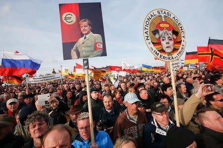 Supporters of the movement Patriotic Europeans Against the Islamisation of the West (PEGIDA) gather for a speech of Dutch anti-Islam politician Geert Wilders during a rally in Dresden April 13, 2015. REUTERS/Fabrizio Bensch