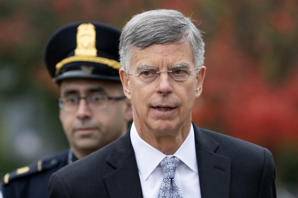 FILE - In this Oct. 22, 2019, file photo, Ambassador William Taylor is escorted by U.S. Capitol Police as he arrives to testify before House committees as part of the Democrats' impeachment investigation of President Donald Trump, at the Capitol in Washington. Taylor, the top U.S. diplomat in Ukraine, told lawmakers last month that President Donald Trump was withholding military aid for Ukraine unless the country’s president agreed publicly to investigate Democrats, according to a transcript of his closed-door testimony released by impeachment investigators on Nov. 6. (AP Photo/J. Scott Applewhite, File)