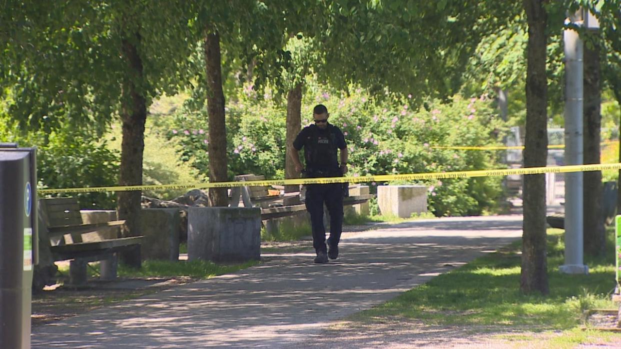 About a dozen VPD officers and park rangers could be seen at Hinge Park Sunday morning, with parts of the park taped off, after an active grenade was found buried in a community garden. (Nav Rahi/CBC - image credit)
