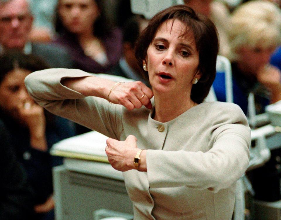 In this Sept. 26, 1995, file photo, prosecutor Marcia Clark demonstrates to the jury how the murders of Nicole Brown Simpson and Ron Goldman were committed during her closing arguments in the O.J. Simpson double-murder trial in Los Angeles. 