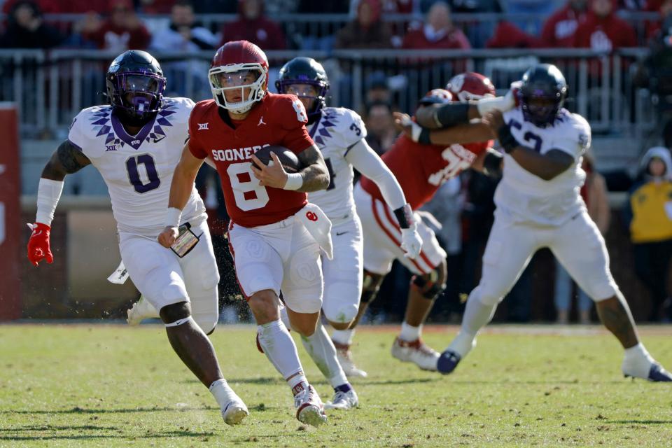 Oklahoma Sooners quarterback Dillon Gabriel (8) runs past TCU Horned Frogs linebacker Shad Banks Jr. (0) for a first down during a college football game between the University of Oklahoma Sooners (OU) and the TCU Horned Frogs at Gaylord Family-Oklahoma Memorial Stadium in Norman, Okla., Friday, Nov. 24, 2023. Oklahoma won 69-45.