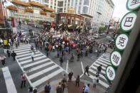 Protesters against police violence stop traffic at a major intersection in the Chinatown neighborhood as they begin a march towards the White House in Washington, April 29, 2015. The marchers joined the cause of those in Baltimore who said they seek answers about the fate of Freddie Gray, who died after suffering spinal injuries while in police custody. (REUTERS/Jonathan Ernst)