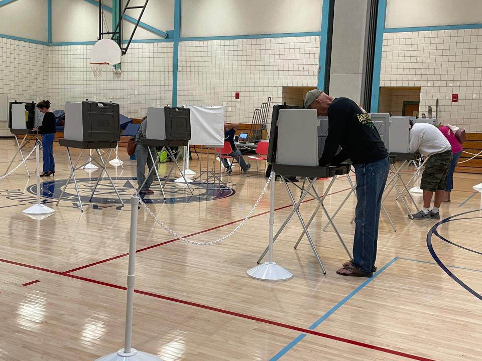 Voters fill out their ballots in the gymnasium at Sandwich's Oak Ridge Elementary School.