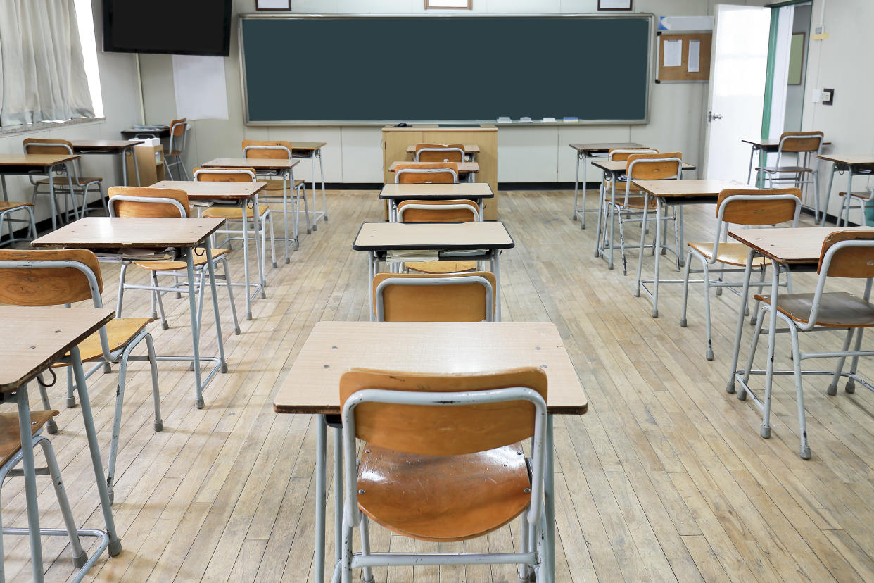 Desks and chairs in an empty classroom.