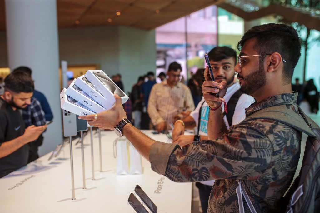 A customer holds newly purchased iPhone 15 smartphones at an Apple Inc. store during the device's first day of sale in Mumbai, India, on Friday, Sept. 22, 2023. Apple's latest iPhones and watches went on sale today, a test of whether a new smartphone design and modest smartwatch changes can help return the company to growth. Photographer: Dhiraj Singh/Bloomberg via Getty Images