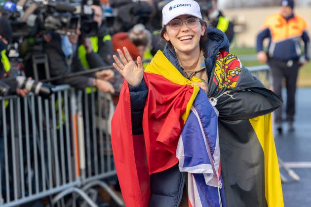 The youngest woman to fly solo around the world, 19-year-old Belgian-British pilot Zara Rutherford, wears the Flags of Belgium and the United Kingdom as she lands her ultralight Shark aircraft after five months circumnavigating the planet. (Photo: Olivier Matthys via Getty Images)