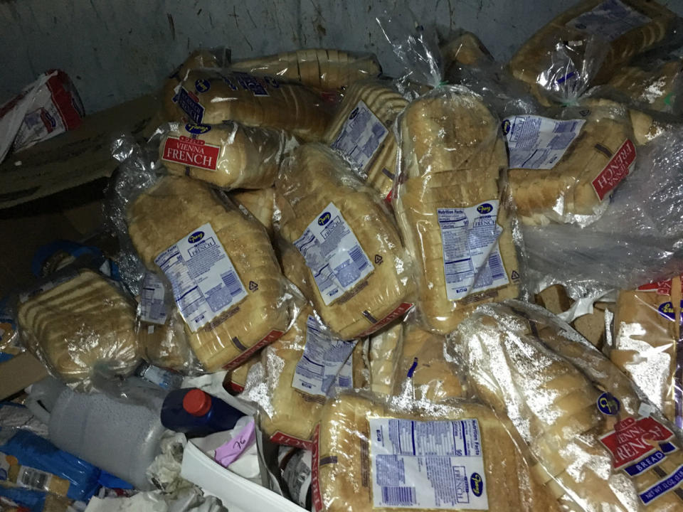 Many loaves of bread are seen. They've been claimed from bins by dumpster diver mum Stacey Cole who saves hundreds each month on her grocery bill.