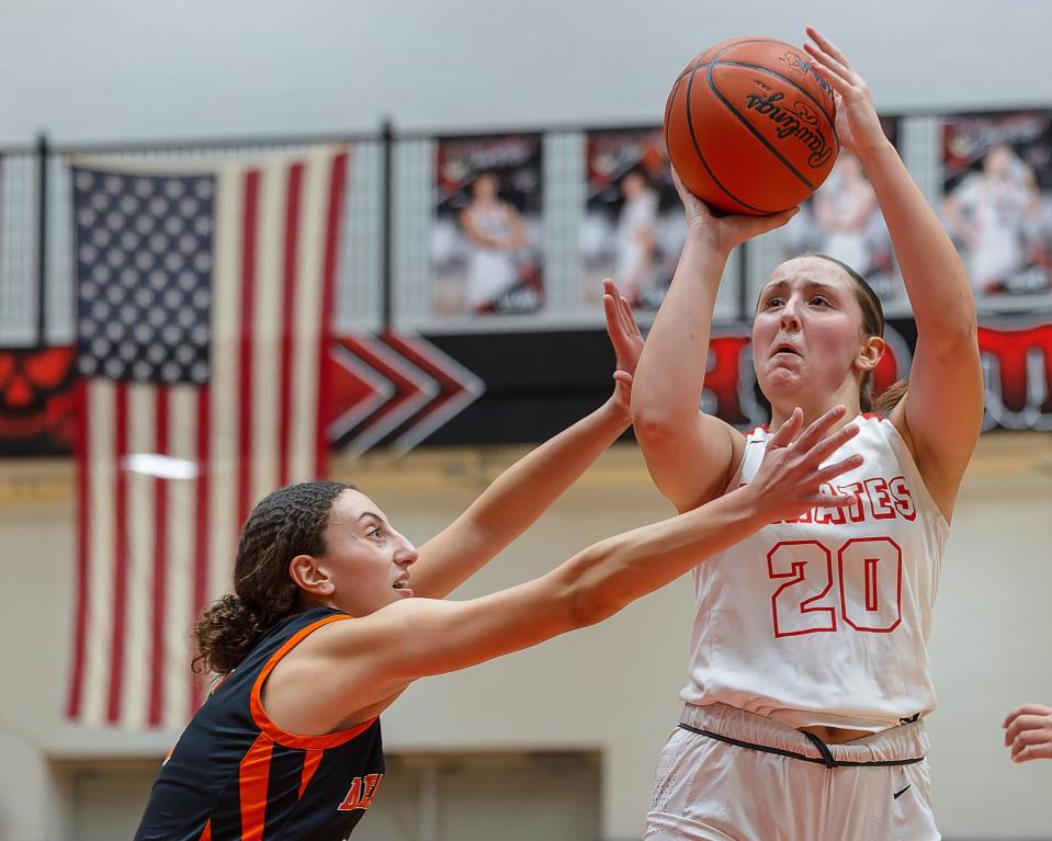 Pinckney's Grace Halash (20) fires up a shot as Dearborn's Katya Salame defends during a season-opening basketball game Monday, Dec. 4, 2023.