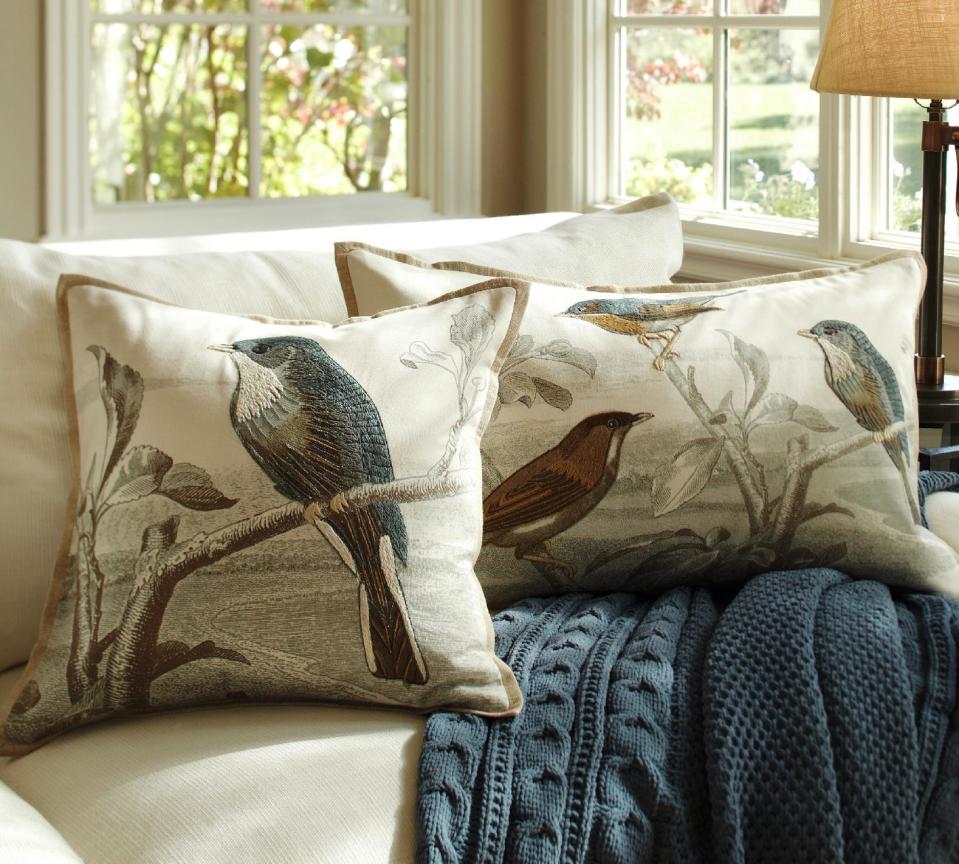 This publicity image provided by Pottery Barn shows Sky Bird embroidered pillow covers from Pottery Barn. Visiting this spring's decor previews often felt like exploring an art gallery. There was an artistic vibe in everything from dinnerware to drapery, art photographs to textiles. (AP Photo/Pottery Barn)