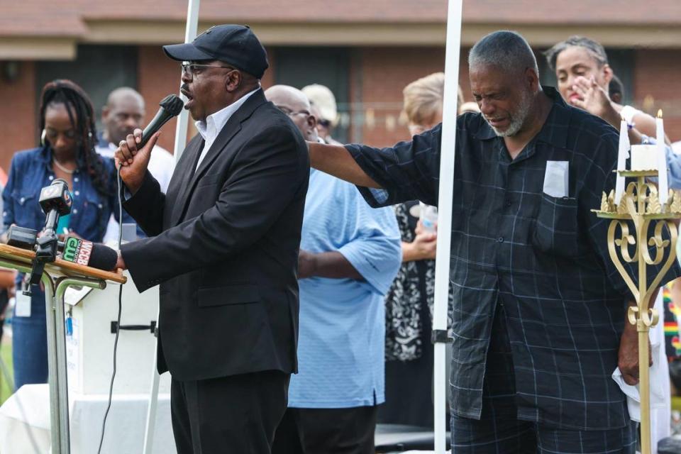 Attendees pray during a vigil for the lives of three youth lost in an apartment fire on Sunday night at Chapman Homes in Concord, NC.