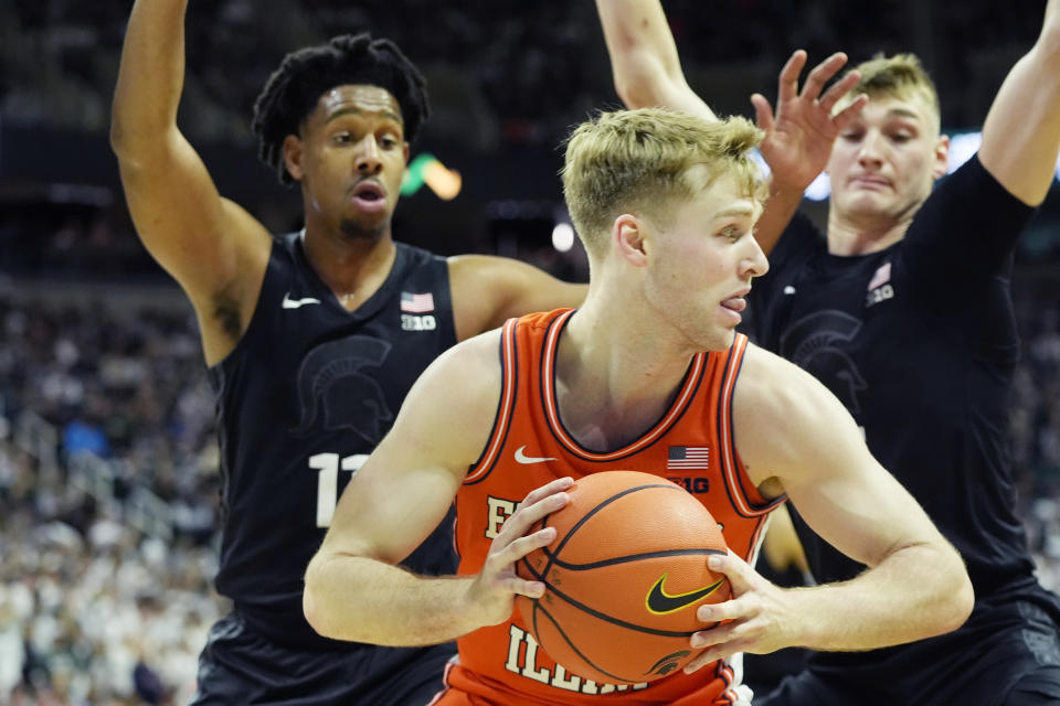 Illinois forward Marcus Domask is defended b Michigan State guard A.J. Hoggard (11) during the first half of an NCAA college basketball game, Saturday, Feb. 10, 2024, in East Lansing, Mich. (AP Photo/Carlos Osorio)
